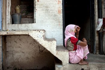 A woman outside her small home in Kanpur, Uttar Pradesh,