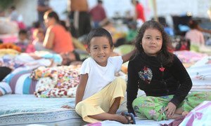 Children sit in a shelter run by a church in Portoviejo, Manabí, in Ecuador.