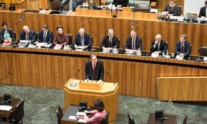 Secretary-General Ban Ki-moon (centre, at lectern) addresses the Austrian Parliament in Vienna.