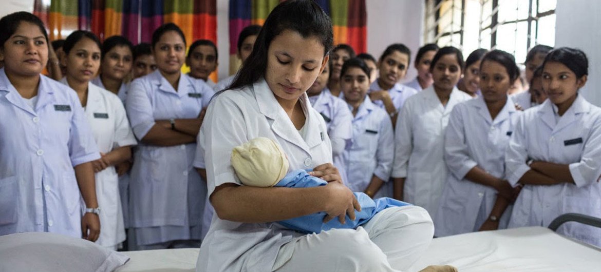 In Dinajpur, Bangladesh, Selina Akter, second year midwifery student, plays the role of a mother as students practice postnatal care at the Dinajpur nursing institute.