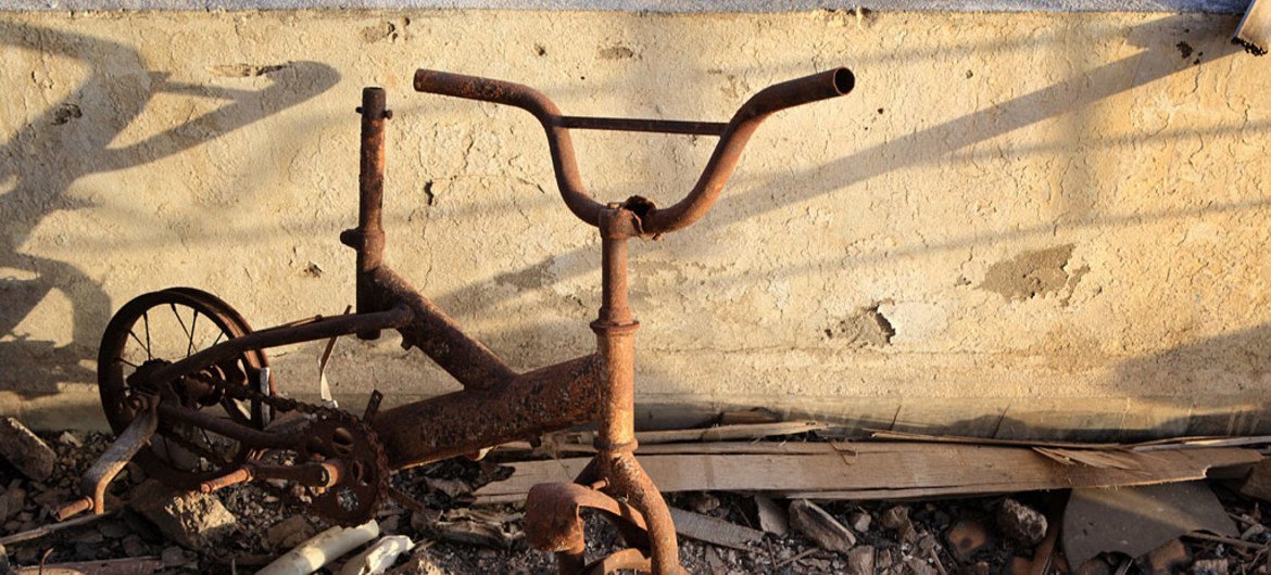 A bicycle, damaged by fire, sits on a third-floor balcony of a destroyed building, in the north-western city of Misrata, Libya.