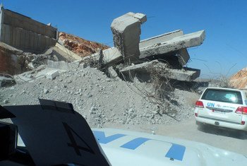 UN vehicles, carrying a humanitarian aid team, pass a destroyed overbridge on their way to Idleb City, capital of Idleb Governorate, Syria, in October 2013.