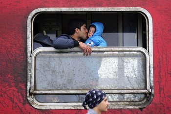 A father kisses his baby boy inside a train outside Vinojug transit center, near the town of Gevgelija, in the Former Yugoslav Republic of Macedonia.
