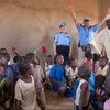 Ann-Marie Orler (standing left), Director of the Police Division, delivers toys to the children of Turba Primary School, North Darfur, with Shereen Bassiouni (right of Ms. Orler), Chief of Police Operations at UNAMID (file photo).