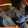 A young boy writes in his maths book in the Tomping Protection of Civilians site, on the base of the United Nations peacekeeping mission in South Sudan (UNMISS) in Juba, the capital.