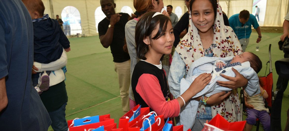 Refugee and migrant children receive recreational materials from the Hellenic Committee for UNICEF and partner Olympiacos Football Club, during a visit to the Eleonas Reception Centre in Athens, Greece.