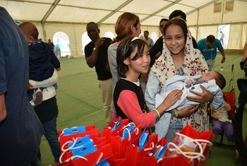 Refugee and migrant children receive recreational materials from the Hellenic Committee for UNICEF and partner Olympiacos Football Club, during a visit to the Eleonas Reception Centre in Athens, Greece.