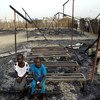 In South Sudan, Chubat (right), 12, sits with her friend in the burned ruins of her UNICEF supported primary school in Malakal Protection of Civilian site, which was burnt down in fighting on 17-18 February 2016.