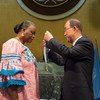 Secretary-General Ban Ki-moon presents the "Captain Mbaye Diagne Medal for Exceptional Courage" to Ms. Yacine Mar Diop,  widow of Captain Diagne.