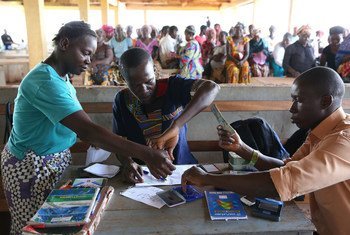 Making cash transfer payments to women in Freetown, Sierra Leone.