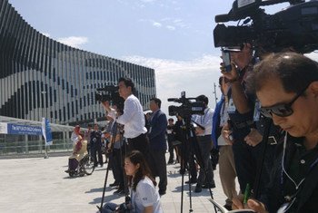 Media gather at the Gyeongju Hwabaek International Convention Center for a flag raising ceremony prior to the 66th DPI/NGO Conference. 29 May 2016.