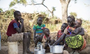 Sudanese refugee Amal Bakith cooks the first breakfast for her children a day after arriving in Ajuong Thok camp, South Sudan. During their long journey from South Kordofan, they had only rotten food to eat.
