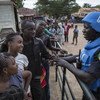 Senegalese peacekeepers from the UN Multidimensional Integrated Stabilization Mission in Mali (MINUSMA) Formed Police Unit (FPU) speak with Malians while they patrol outside Mamadou Konate Stadium during an event to promote peace among the youth.