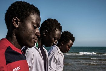 A group of Gambian boys survey the ocean from the beach during an outing from a Government reception centre that doubles as a lodging station for unaccompanied minors in Pozzallo, Sicily, on May 17, 2016.