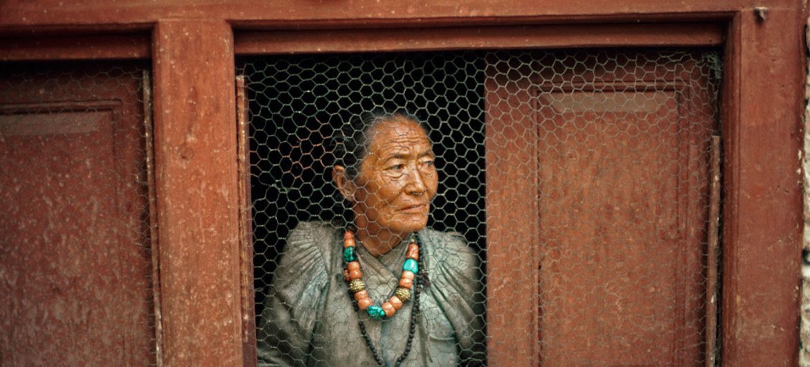 An old woman at her window in a Nepalese village.