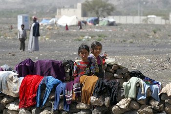 In Yemen, internally displaced children stand outside their family tent after the family fled their home in Saada province and found refuge in Darwin camp, in the northern province of Amran.