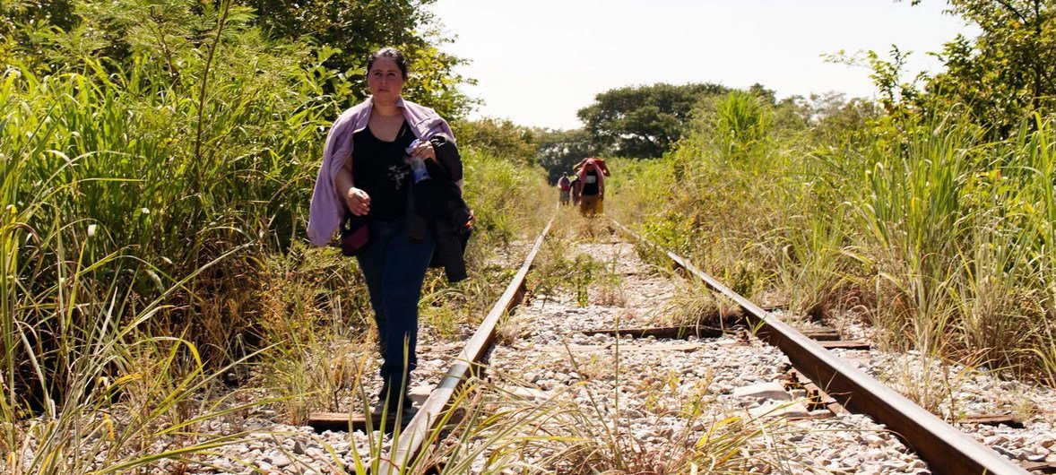 A woman fleeing from El Salvador walks along the train tracks in Chiapas, Mexico. This stretch of her walk began on Arriaga, Chiapas. She is on her way to the United States. Mexico. Central American Refugees.