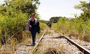 A woman fleeing from El Salvador walks along the train tracks in Chiapas, Mexico. This stretch of her walk began on Arriaga, Chiapas. She is on her way to the United States. Mexico. Central American Refugees.