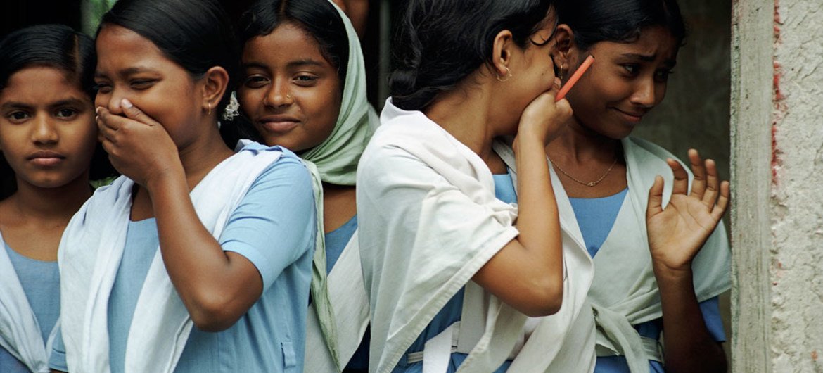 Students laugh as they leave school in Bangladesh.