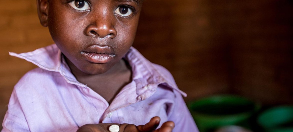 Photographed in August, Longezo is 3 and living with HIV in Nkhuloawe Village, Malawi. Here is taking his medication. His life was saved when Bizwick visited his home and discovered he was very ill and in need of medical attention.