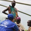 This photo from November 2014 shows IOM providing transportation assistance in South Sudan, moving vulnerable refugees on a UNHCR helicopter.