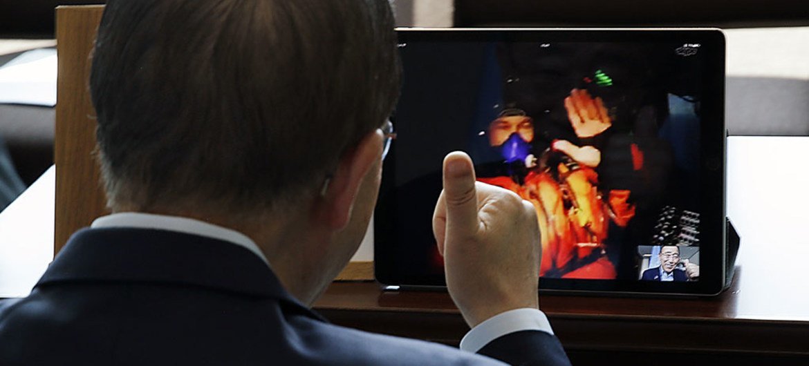 Secretary-General Ban Ki-moon (right) speaks with Solar Impulse pilot Captain Bertrand Piccard (on screen) via Skype video chat.