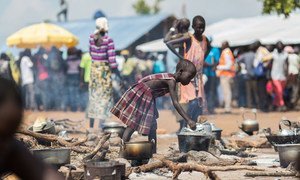 A young South Sudanese refugee cooks food at a camp in northern Uganda