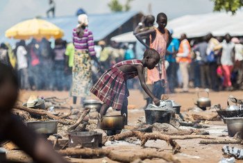A young South Sudanese refugee cooks food at a camp in northern Uganda