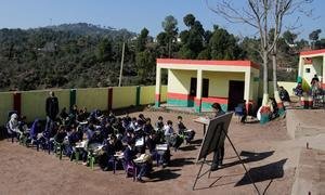 Children attend class in open at a government middle school, Rajouri district, Jammu and Kashmir, India.