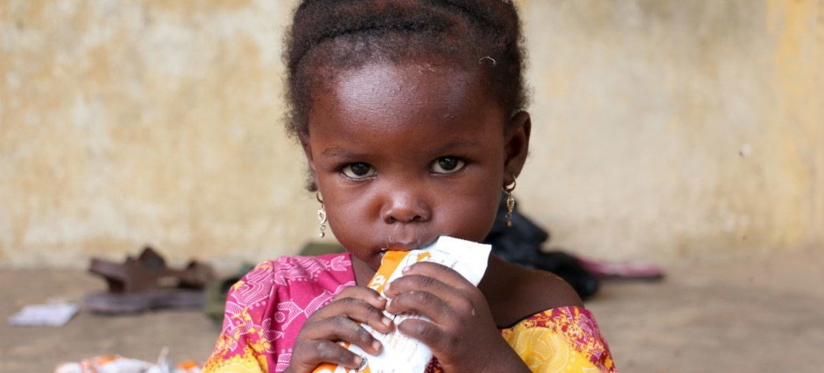 After fleeing Boko Haram violence, a child, at Dalori 2, a displaced people’s camp located on the outskirts of Maiduguri, Nigeria, eats Plumpy’sup, a ready-to-use, highly nutritious food to combat malnutrition.