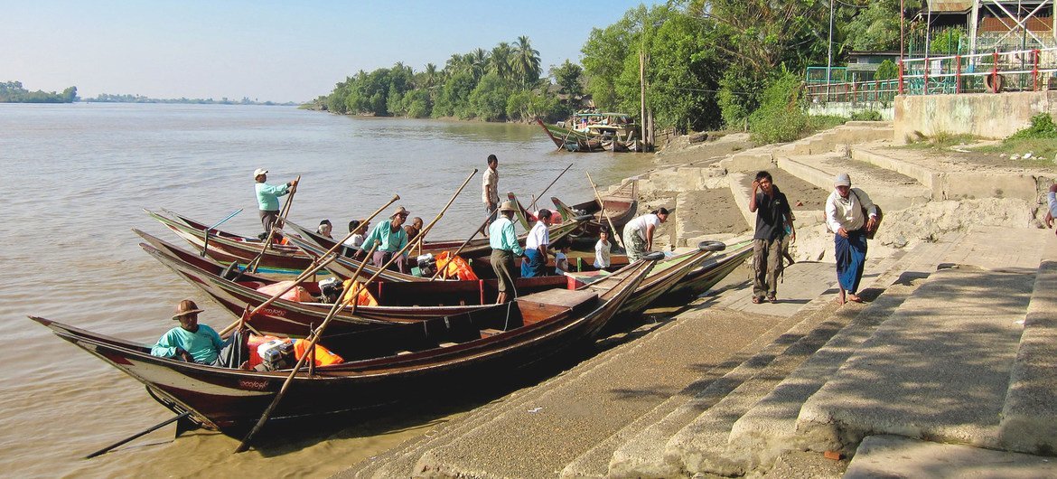 Boatmen wait to ferry pilgrims to the Yele Paya floating pagoda in Myanmar.