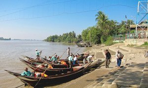 Boatmen wait to ferry pilgrims to the Yele Paya floating pagoda in Myanmar.