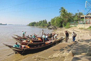 Boatmen wait to ferry pilgrims to the Yele Paya floating pagoda in Myanmar.