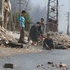 On 20 August 2016, children play near a broken water main, which was damaged by fighting in the Sheikh Saeed neighbourhood in eastern Aleppo, Syria.