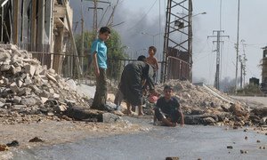 On 20 August 2016, children play near a broken water main, which was damaged by fighting in the Sheikh Saeed neighbourhood in eastern Aleppo, Syria.