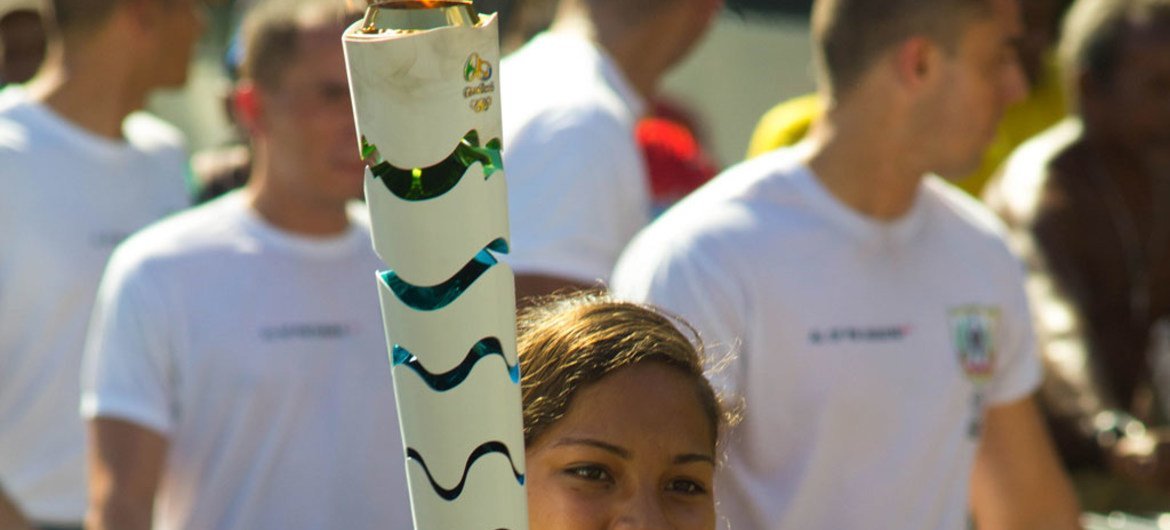 Adriana Almeida Santos, 15, carries the Olympic Flame in the city of Belém in state of Pará, Brazil.