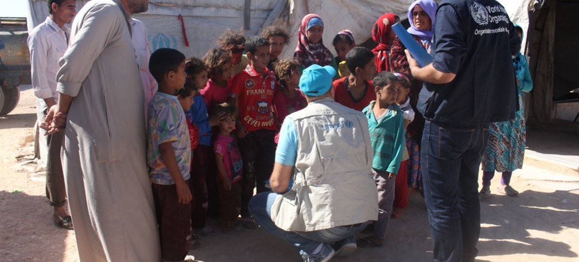 On 13 September 2016 in the western part of Aleppo city, Syria, UNICEF representatives speak with displaced mothers and children living in make-shift tents and shelters in the neighbourhood of Majabel.