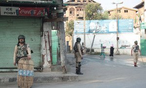 Women walking past Indian security forces in Srinagar, summer capital of the Indian state of Jammu and Kashmir.