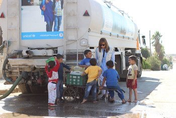 UNICEF Representative in Syria Hanaa Singer shown with children during a visit on 29 September 2016 to western Aleppo, where she met with UNICEF health, water and sanitation partners.