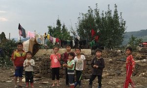 Children in Hoeryong City, Democratic People's Republic of Korea (DPRK), observe the UN inter-agency assessment mission that evaluated the needs of people affected by floods in September  2016.