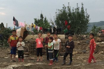 Children in Hoeryong City, Democratic People's Republic of Korea (DPRK), observe the UN inter-agency assessment mission that evaluated the needs of people affected by floods in September  2016.