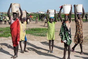 In South Sudan, girls carry water for their families.