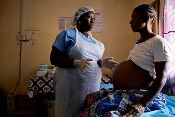 A midwife examines a pregnant woman at a health clinic near Moyamba, Sierra Leone.