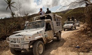 Brazilian peacekeepers and a police officer from the United Nations Mission in Haiti (MINUSTAH) head out on patrol to the town of Jeremie, which was heavily damaged by Hurricane Matthew.