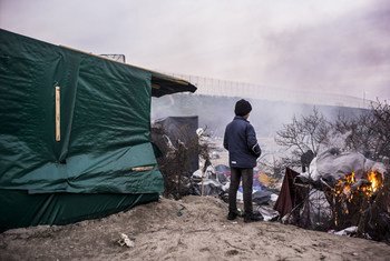 A young resident at the so-called Calais 'jungle' views the harsh winter landscape of the temporary center, home at times to several thousand persons.