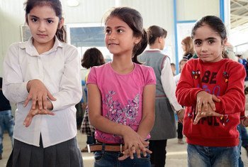 Syrian children follow along during a handwashing demonstration at a school in Domiz Camp for Syrian refugees in Dohuk Governorate, Iraq.