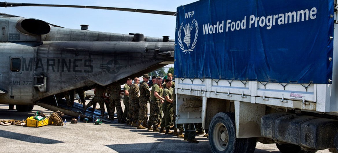 US Marines unloading over 12 tonnes of food items from a World Food Programme (WFP) truck onto helicopters to be sent to Jeremie, Haiti, which was severely hit by Hurricane Matthew.