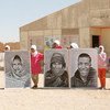 Refugees from Western Sahara hold up large portraits outside the Smara refugee camp near Tindouf, Algeria.