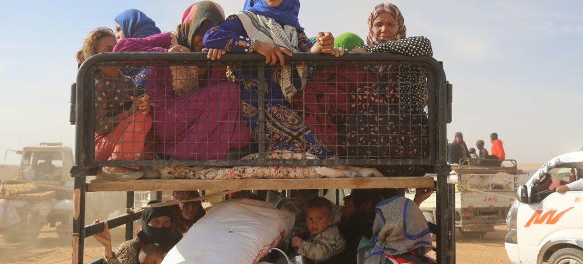 Displaced children and adults in Syria are seen in a vehicle after fleeing from ISIL-controlled areas in rural Raqqa to Ain Issa, the main staging point for displaced families, some 50 kilometres north of Raqqa city.