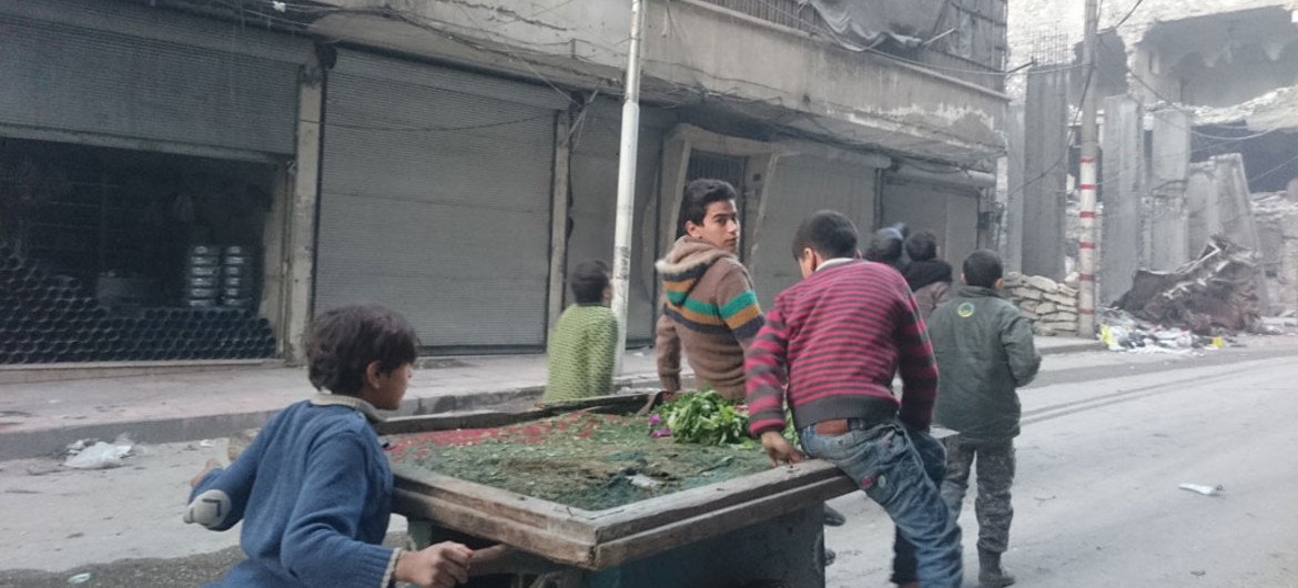 On 20 November 2016, a group of children push a cart trying to sell some radish in Al-Sha’ar neighbourhood in Aleppo, Syria. Food and other basic commodities are running out at one of East Aleppo’s once busiest markets.